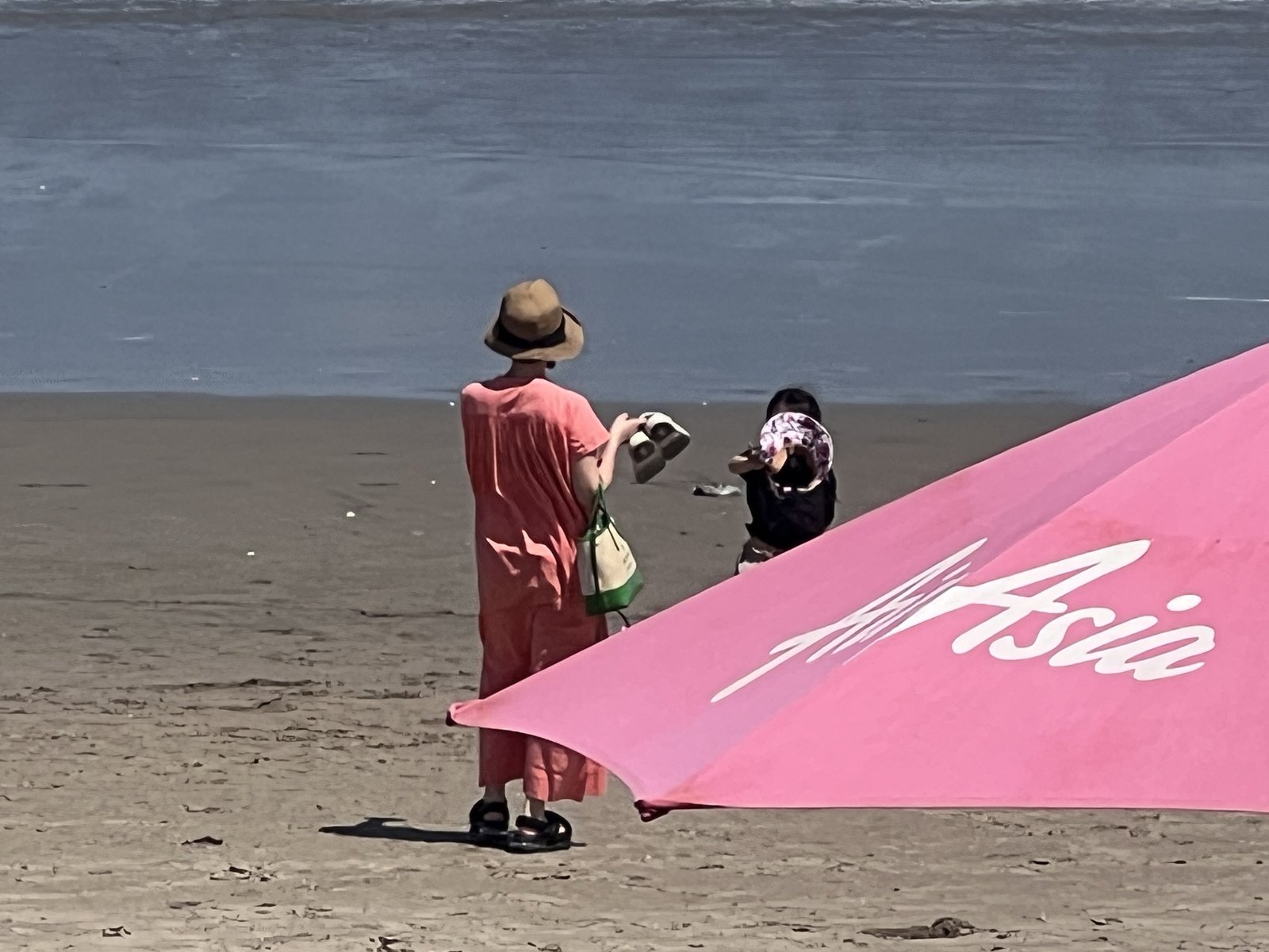 Walking the beach past the pink umbrellas 