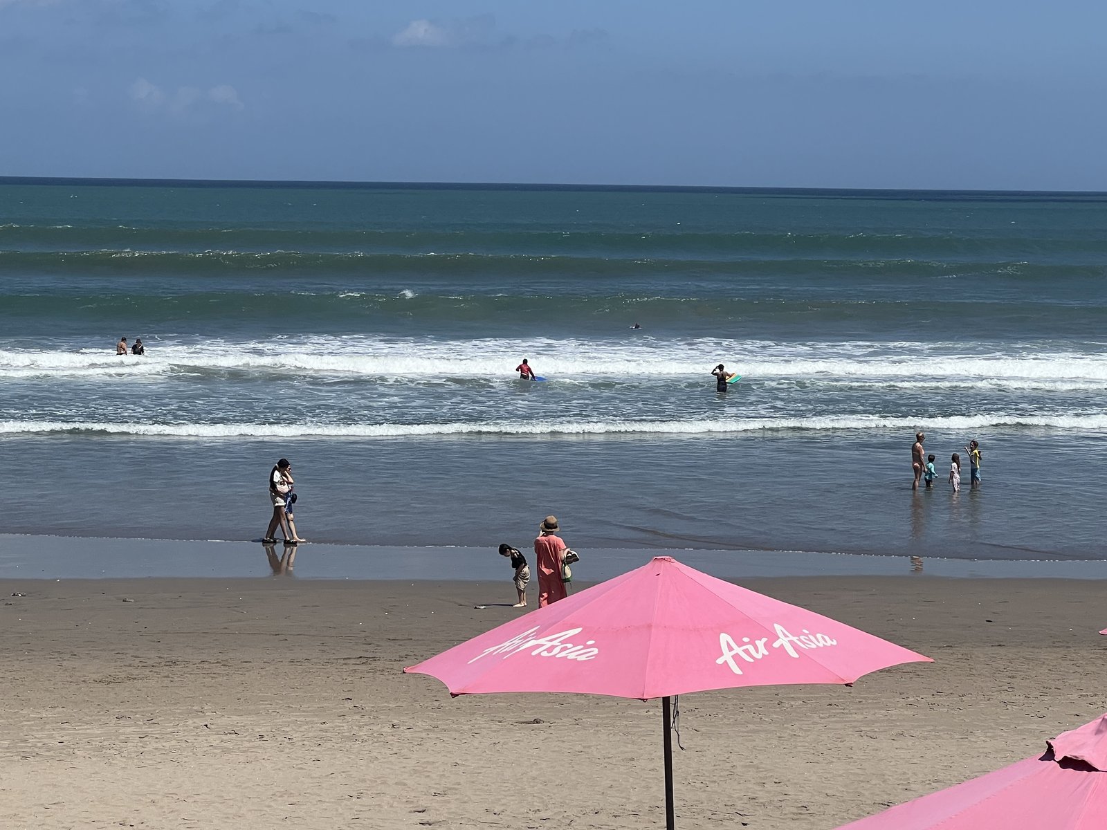 People playing in the waves along the beach 