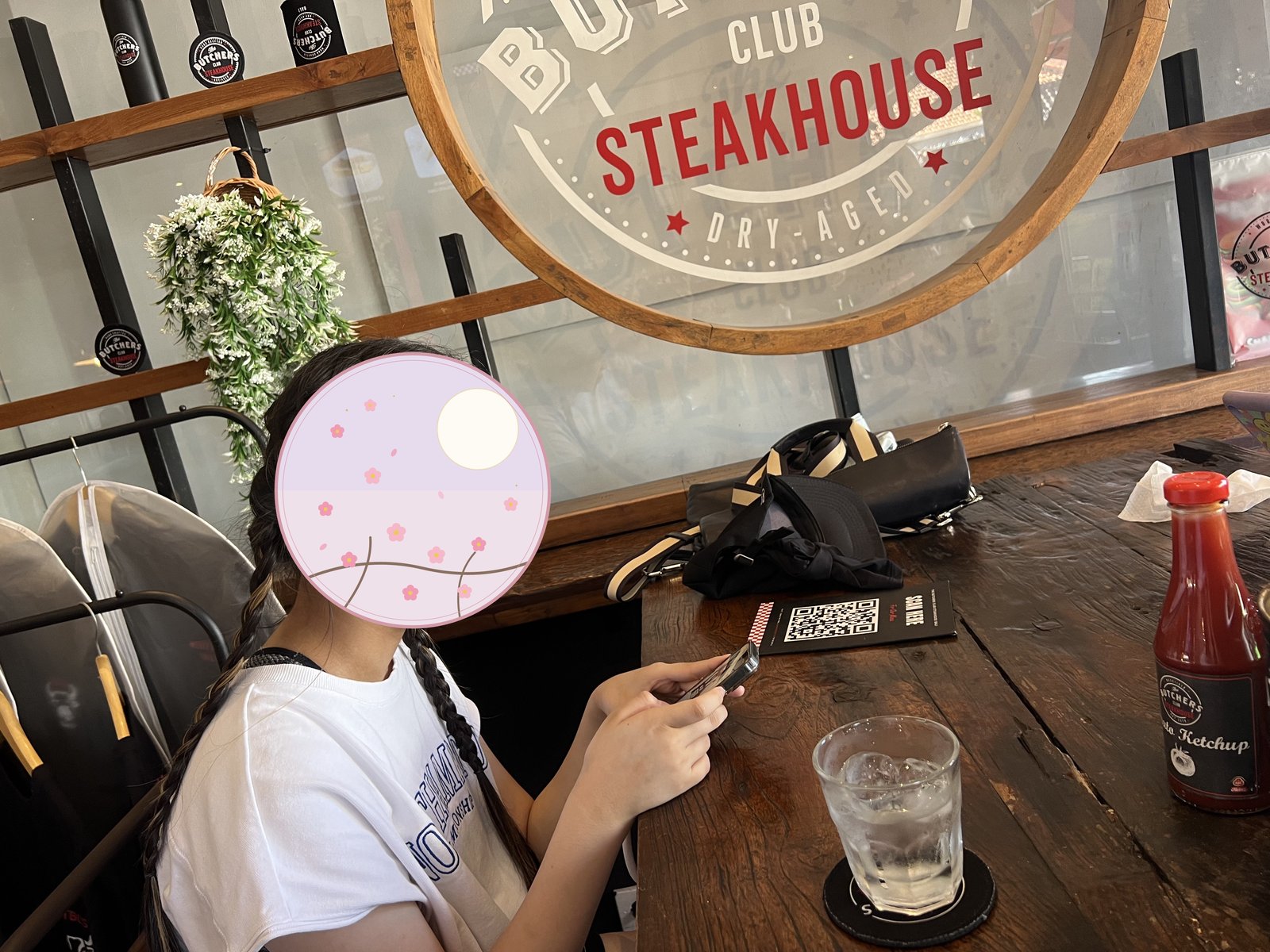The steakhouse sign, with our child getting ready to eat 