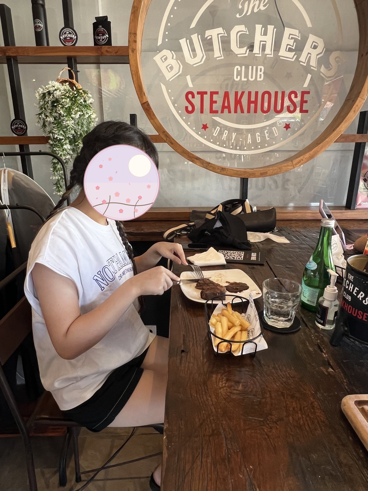 Steak and fries in front of our child at the table 