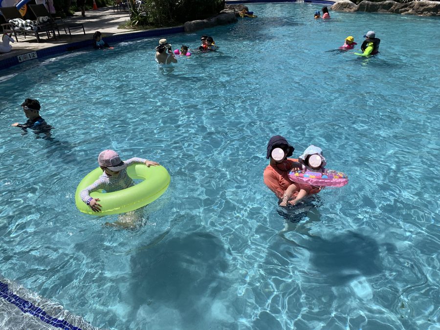 Cousins playing together on their floats.