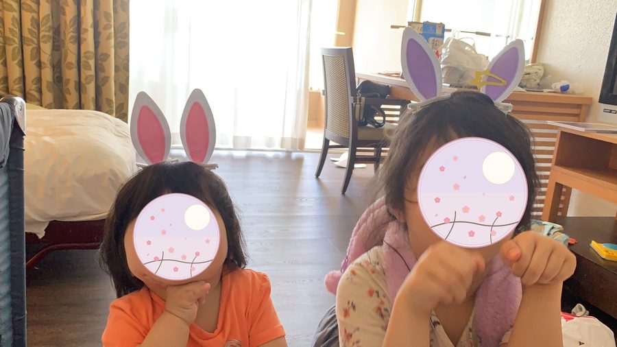 Wearing rabbit ears.