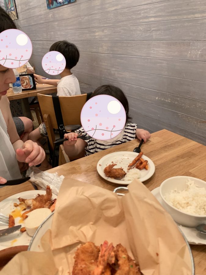 Their mother and the two children, eating together.