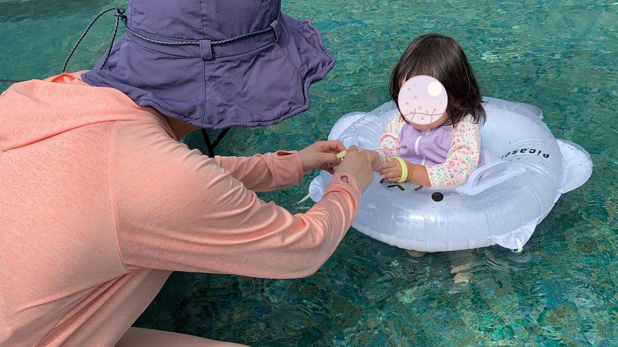In a ring float. She was still too young to swim on her own.