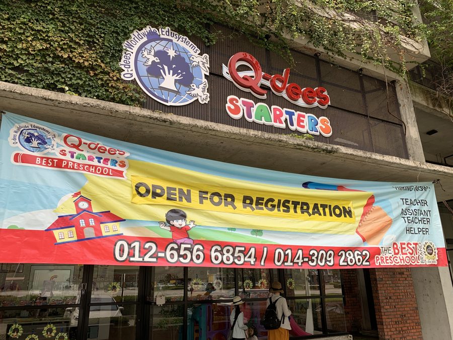 A kindergarten nearby, with an enrolment banner out front.
