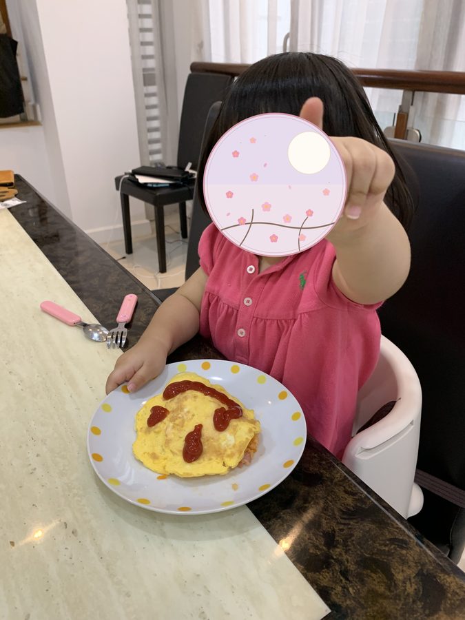 A rice omelette with a face drawn on in ketchup.