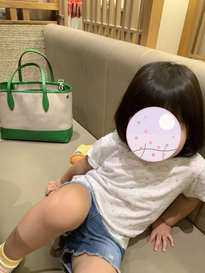 Holding hands with her elder sister.