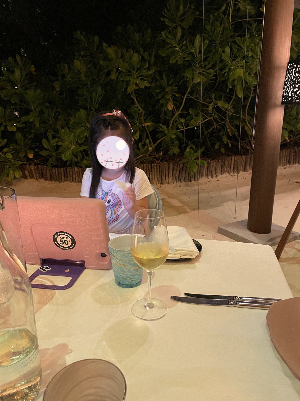 砂浜のディナー会場でくつろぐ子ども