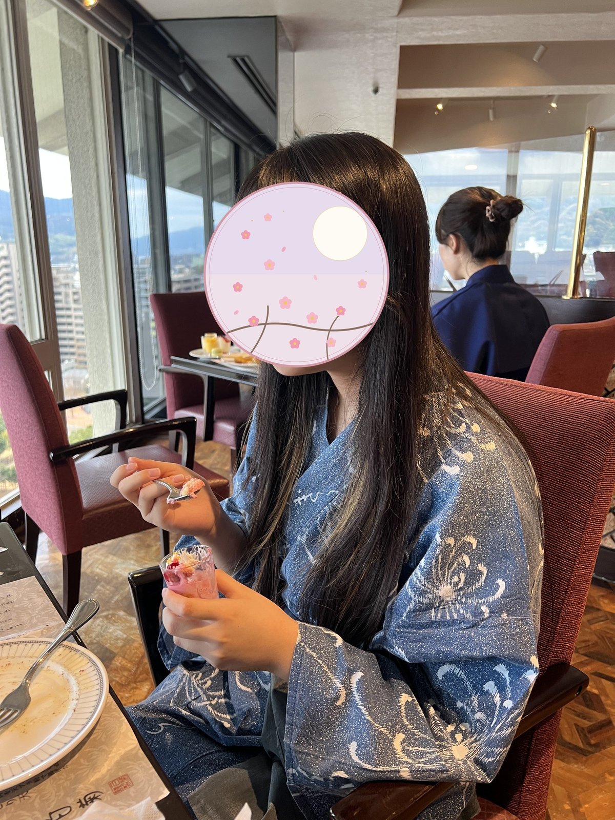 Our child enjoying dessert with Beppu's cityscape in the background