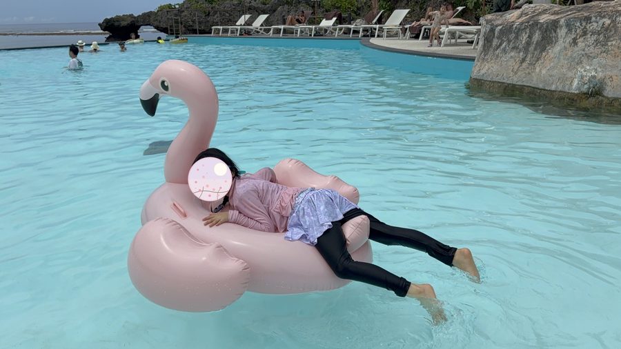 Drifting on a float. You float more easily in the saltwater pool.