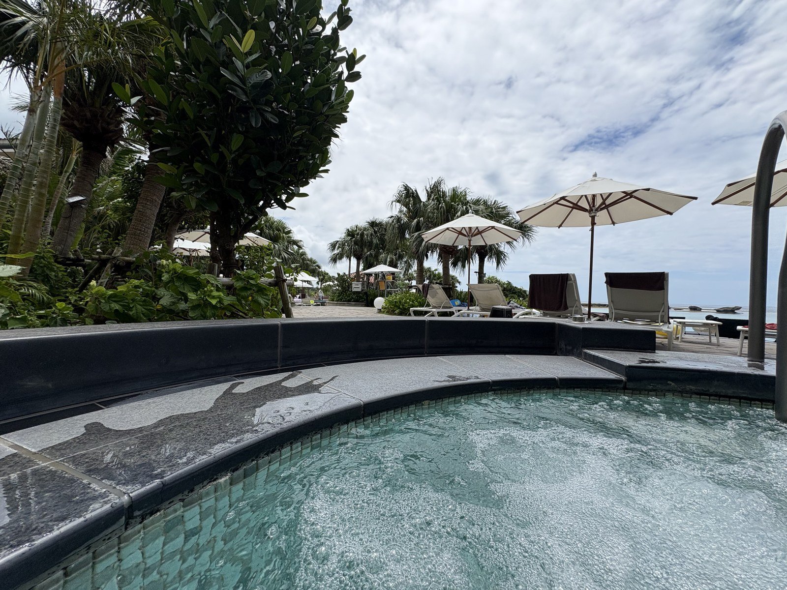 The poolside in the morning — towels laid out, nobody in yet