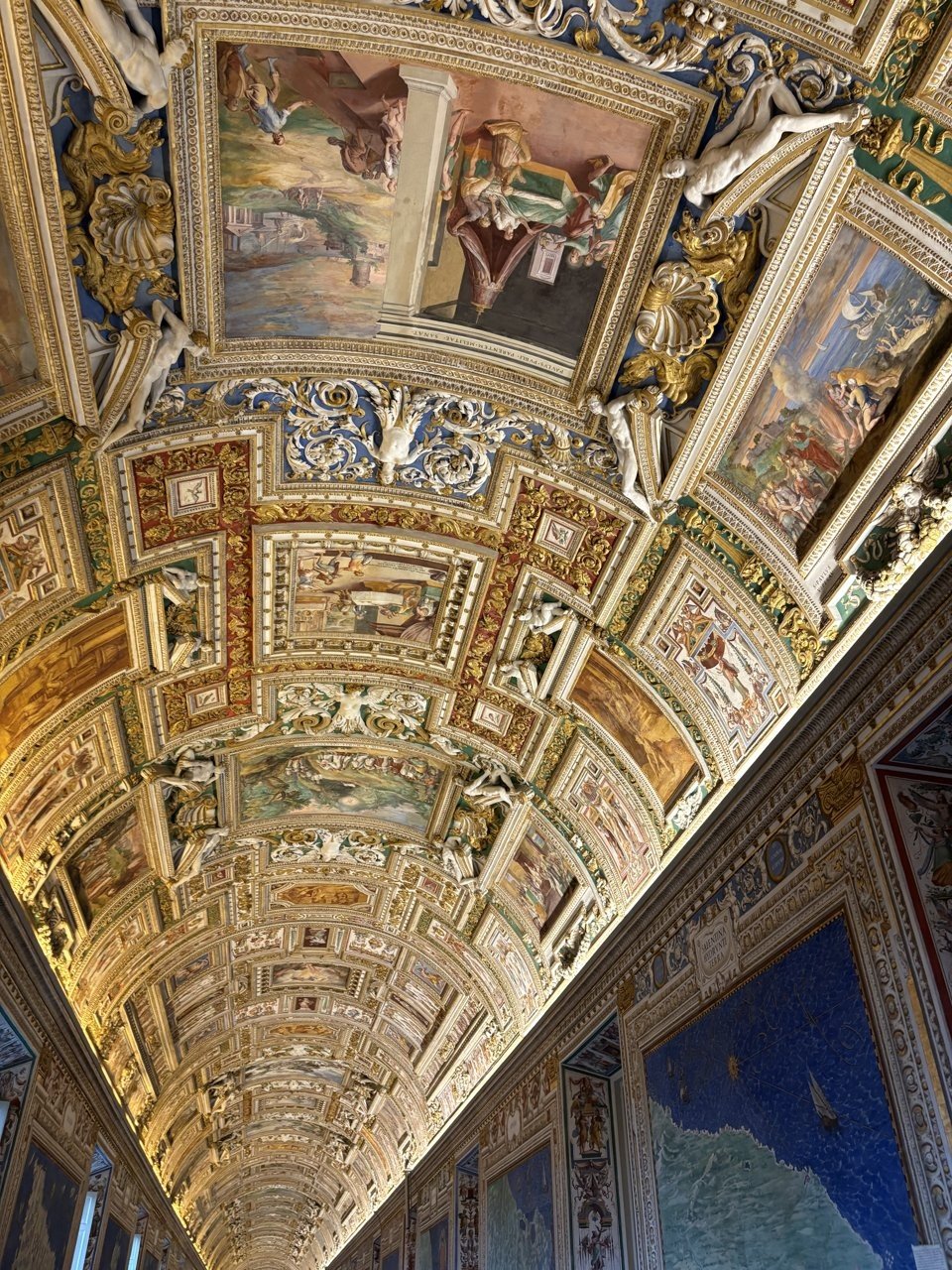 The Gallery of Maps, with its gilded ceiling and walls of antique maps